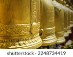 Small photo of Golden bells hang in a row at Thai Buddhist temples for tourists to use to knock on to make a loud sound to reverberate beliefs to become famous like bells..