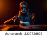 Small photo of Photo of mysterious valkyrie interact dead spirit animal fur potion orange blue lights isolated on dark background