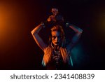 Small photo of Portrait of dangerous fearless valkyrie girl hold potion cup above head orange lights isolated on dark background