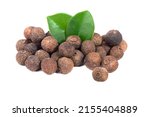 Pile of allspice isolated on white background. Jamaica pepper, allspice peppercorns or myrtle pepper with green leaves.