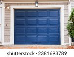 Small photo of garage door stands tall, symbolizing security and convenience. A gateway to shelter cars and storage, it complements the home's aesthetic while ensuring protection