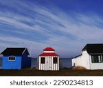 Row of colourful beach huts against blue sky on Danish island of Aeroe. High quality photo