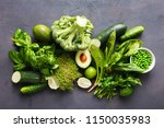 Set raw healthy food clean eating vegetables source of protein for vegetarians: cucumber, lucerne, zucchini, spinach, basil, green peas, avocado, broccoli, lime on black background, top view
