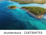 Camping, vacation concept. Beautiful Medulin aerial view. Top view from drone of coastline at sunset to a tent city on a peninsula, colorful seascape, Croatia