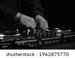 Black-and-white DJing hand photographs dj