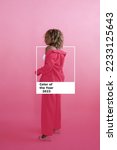 Small photo of Color Pantone 2023 Viva Magenta color. New trend color. One wall. African American woman in color of the year costume on a plain background in the studio