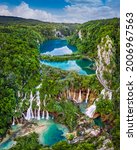 Plitvice, Croatia - Panoramic view of the beautiful waterfalls of Plitvice Lakes in Plitvice National Park on a bright summer day with blue sky and clouds and green foliage and turquoise water