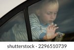 Small photo of Child trapped in a car on a hot day. Conceptual image of overheating danger in the car for young children in summer