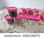 Small photo of a bunch of malaysia kuih raya in a container on a table. kuih raya always serve for visitor during hari raya.