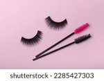 Small photo of Eyelash extension brushes on a lilac background. Brush for combing extended and false eyelashes. Brush for straightening eyelashes and eyebrows.