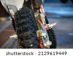 Small photo of the rear wheel of a motorcycle with a tread for off-road and enduro. Large wheel tread. close-up. selective focus. blurred background.