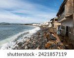 Small photo of Effects of climate change on the coast of the Pacific Ocean, houses on the verge of collapse due to sea level rise, rock barrier. Barra de Navidad, Cihuatlan, Jalisco, Mexico: 2 February 2024.