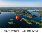 Aerial summer sunny sunset view of hot air balloon over Galve lake, Lithuania