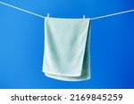 Green towel drying on clothesline