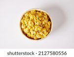 Small photo of Mote pillo, a typical ecuadorian side dish that consists of hominy sauteed with onions, eggs and milk. It’s served on a bowl and on a white background.