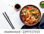 Stir fry noodles with chicken, red paprika, mushrooms, chives and sesame seeds in bowl. Asian cuisine dish. White table background, top view