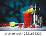 Small photo of Bloody Mary cocktail drink with tomato juice, vodka, lemon, celery, hot sauce and ice in glass garnished with salt and ground chili pepper. Dark green background, hard light and shadow pattern