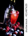 Small photo of Alcoholic cocktail strawberry malarkey with fresh berries, liquor and champagne brut, dark background, selective focus