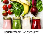 Multicolored smoothies and juices from vegetables, fruits and berries, food background, top view