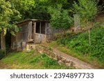 A small wooden farm building and a chicken enclosure in Martin Brod in the Una National Park. Una-Sana Canton, Federation of Bosnia and Herzegovina. Early September