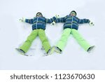 happy boys in colorful winter... | Shutterstock . vector #1123670630