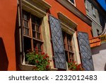 Facade of antique historical building. Windows with flowers. Lviv, Ukraine. European travel photo.