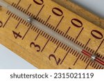 room thermometer on a wooden base close up on a white background. Celsius degree scale.