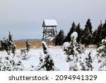 A Bird watching tower in a field covered with snow. Selective focus. High quality photo