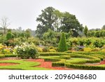Garden in a french style with plants trimmed up in a classic forms. Selective focus. High quality photo