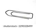 Extreme close up of large silver metal paper clip against white background with copy space as concept for office paperwork and administration