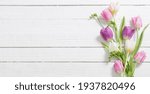 Spring Flowers On White Wooden...