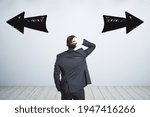 Small photo of Businessman puzzled, two black arrows, right, left, path dilemma, choice concept
