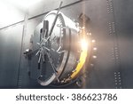 Closeup of an open bank vault door with golden light peeking from inside. 3D Render