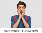 Small photo of Horizontal shot of stupefied Caucasian male stares at camera with bated breath, has astonished expression, finds out about smuggling in his business, isolated over white background. Shock concept