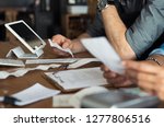 Mature smalll business owners calculating finance bills of their activity. Business people using calculator to work. Closeup hands of man and woman calculating bills and expenses. 