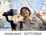 Millennial hipster teen girl blogger influencer record vlog on smart phone holf selfie stick. Travel vlogger shoot video blog instagram story,streaming on urban city street get likes and hearts emoji.