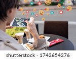 Female blogger influencer hold phone take food mobile photo on phone sit at cafe table. Girl vlogger shoot social media instagram post on smartphone get many likes emoji over shoulder closeup view.
