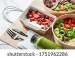 Healthy meal slimming diet plan daily ready menu background, organic fresh dishes and smoothie, fork knife on paper eco bag as food delivery courier service at home in office concept, close up view.