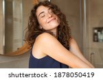 Happy young woman feeling relaxed with eyes closed. Smiling woman stretching with hands forward feeling fresh on a bright morning. Beautiful girl stretch herself in the morning.