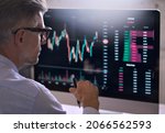 Crypto trader investor analyst broker using pc computer analyzing online cryptocurrency exchange stock market indexes charts investing money profit in trading platform stockmarket. Over shoulder view.