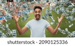Small photo of online betting, gambling and sport concept - happy man with raised hands and money rain over football field background