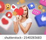 social media, blogging and people concept - smiling young woman with red heart over internet icons on grey background