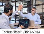Small photo of Two happy successful excited diverse traders investors giving high five celebrating successful stock exchange trading deal, rising crypto bull market shares growth, ipo profit victory concept.