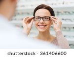 woman choosing glasses at optics store