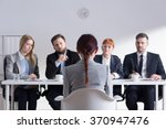 Woman during job interview and four elegant members of management