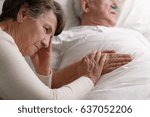 Elderly Woman Holding Sick...