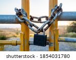 Padlock And Chain At Gate In...