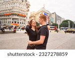 happy young adult heterosexual couple smiling hugging in the city of Buenos Aires