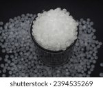 Small photo of High density polyethylene plastic granules on a black background, this virgin polymer is one of the basic materials in the plastics industry