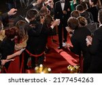 celebrity on the red carpet. man and woman in evening dresses among photographers and fans on the red carpet